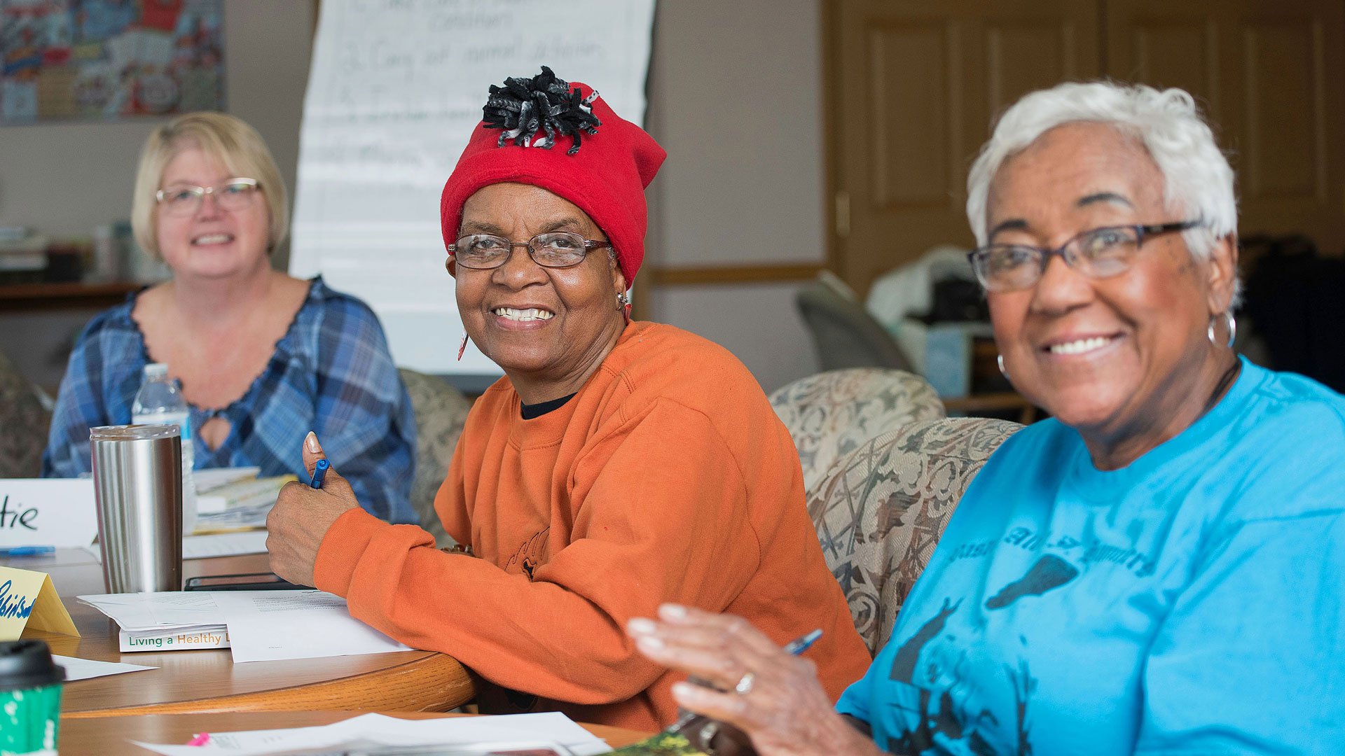 A photo of three people sitting together at a table.