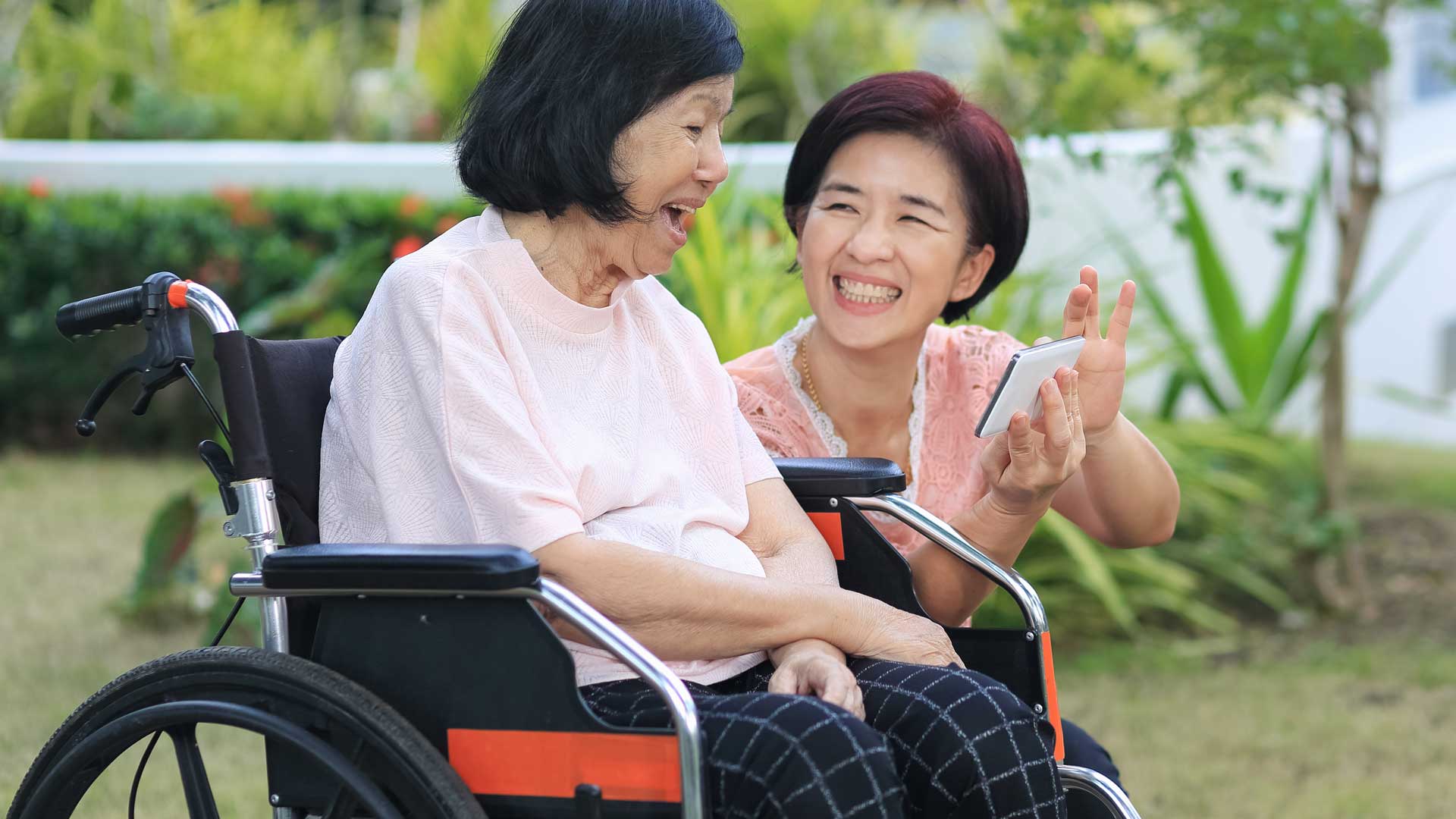 Photo of two people laughing together.