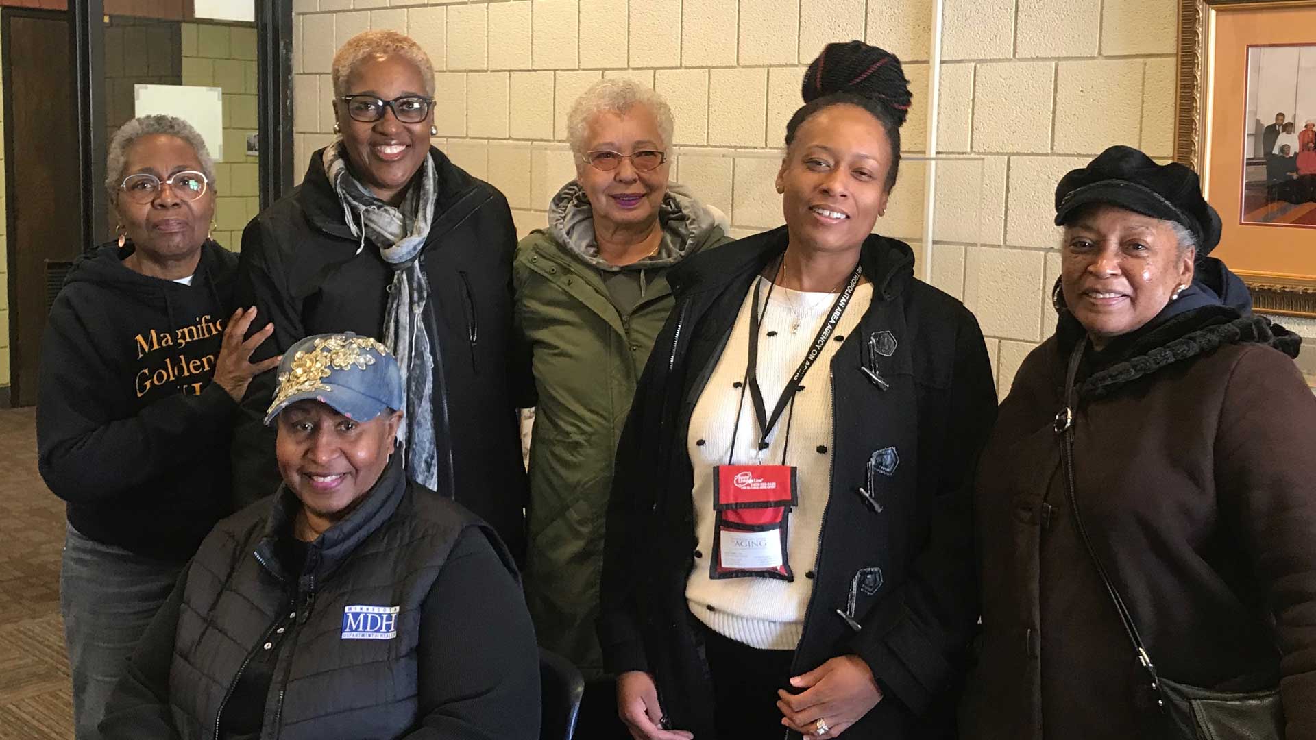 Photo of five people standing together.