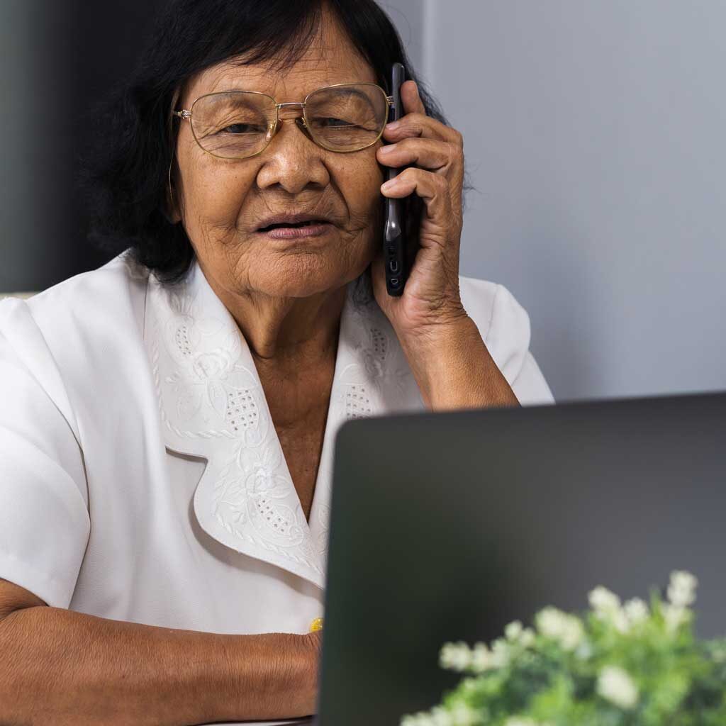 Photo of an older adult speaking on the phone.