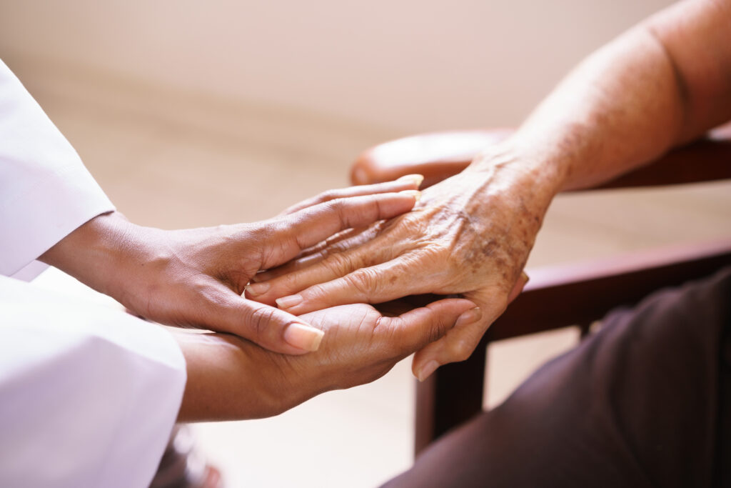 Close-up photo of two people holding hands.