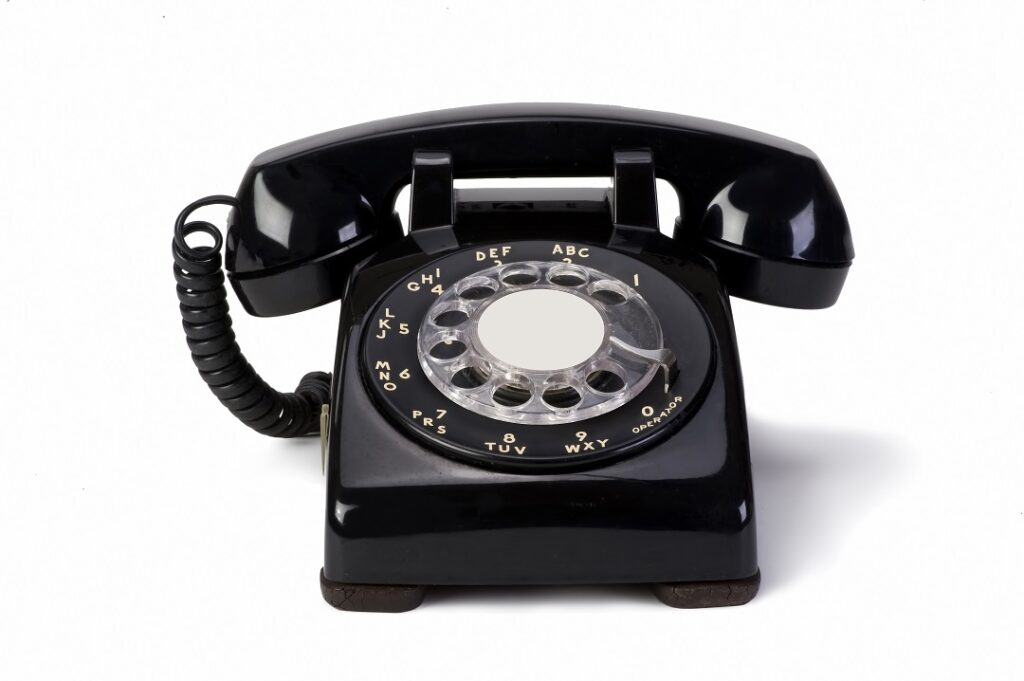 A black rotary telephone.