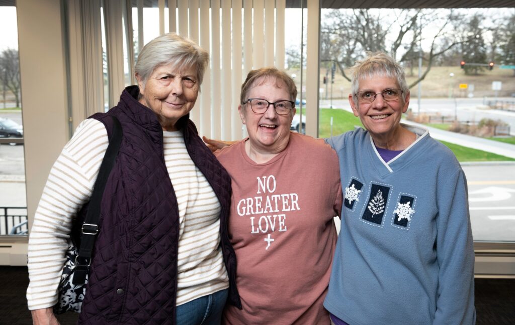 Photo of three women standing together.