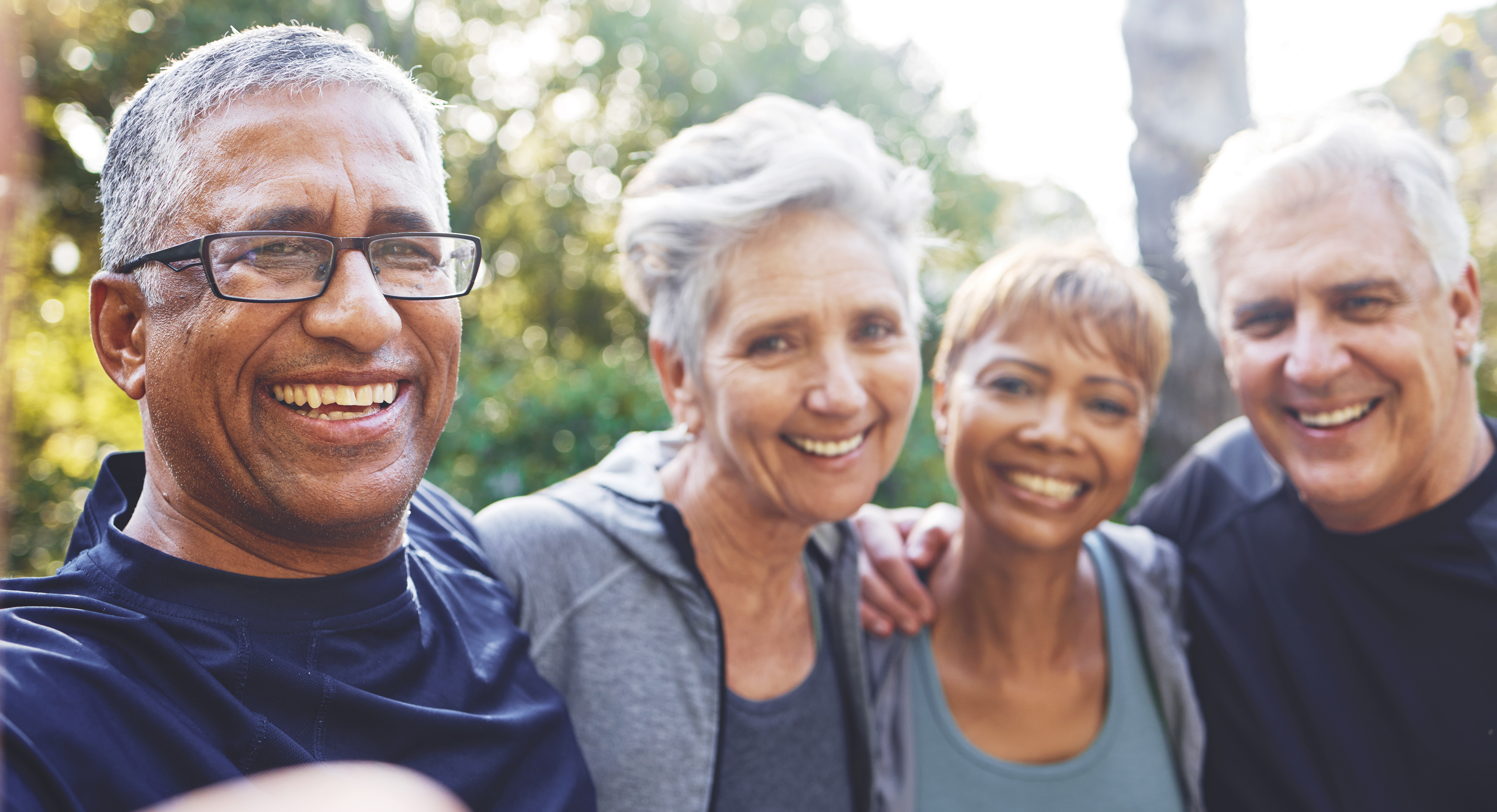 Photo of four older adults outside.