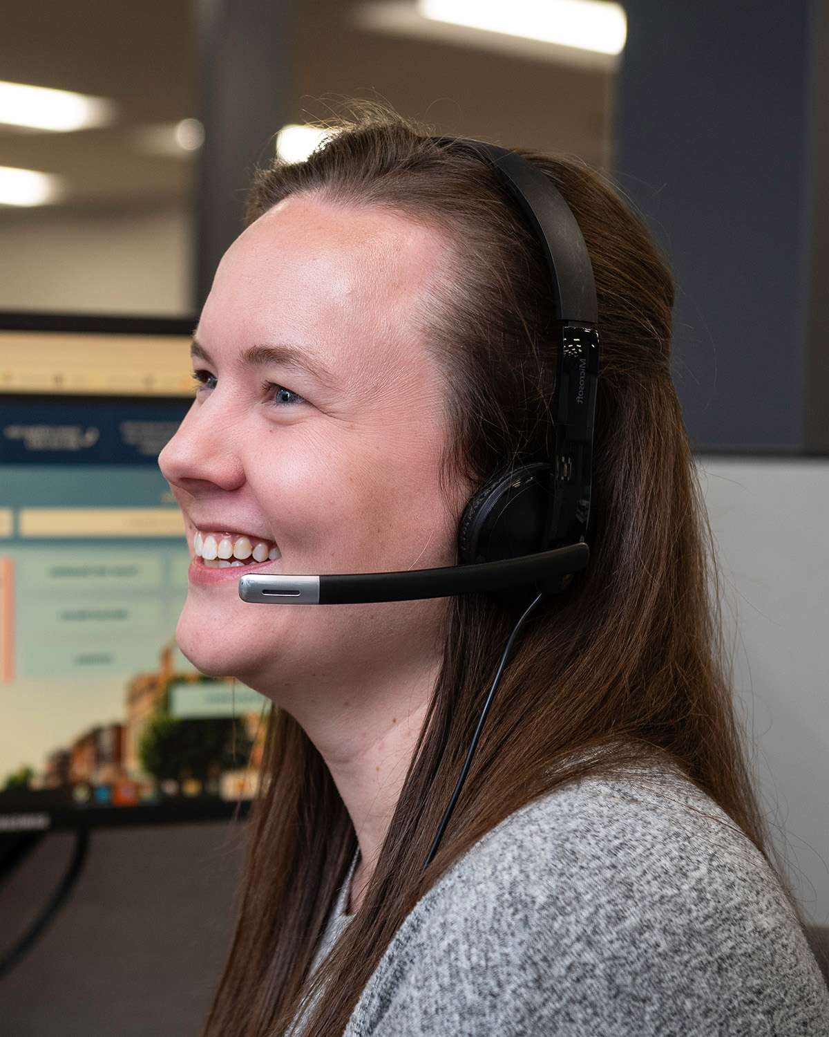 Photo of a woman talking on a headset.