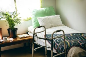 Photo of an empty bed with a walker next to it.